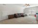 Spacious bonus room with a cozy sectional sofa, bed, and plenty of natural light at 11806 Stirling Field Dr, Pineville, NC 28134