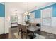 Dining room features chandelier, white wainscoting, wood table, and windows at 11806 Stirling Field Dr, Pineville, NC 28134