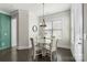 Bright dining area with round table, chandelier, dark floors and natural lighting at 11806 Stirling Field Dr, Pineville, NC 28134