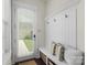 Inviting entryway with a bench, hooks, and a door leading to the outdoors at 11806 Stirling Field Dr, Pineville, NC 28134