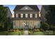 Charming two-story home featuring a welcoming front porch and well-manicured lawn at 11806 Stirling Field Dr, Pineville, NC 28134