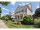 Charming two-story home with a welcoming front porch and well-manicured landscaping at 11806 Stirling Field Dr, Pineville, NC 28134