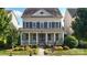 Inviting two-story home with a classic front porch and beautiful curb appeal at 11806 Stirling Field Dr, Pineville, NC 28134