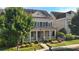 Attractive two-story home with a covered front porch and lush landscaping around the yard at 11806 Stirling Field Dr, Pineville, NC 28134