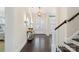 Elegant foyer with hardwood floors, a staircase, and stylish decor at 11806 Stirling Field Dr, Pineville, NC 28134