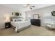 Comfortable main bedroom features natural light, ceiling fan, and dark dresser at 11806 Stirling Field Dr, Pineville, NC 28134