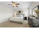 Comfortable main bedroom features natural light, ceiling fan, and dark dresser at 11806 Stirling Field Dr, Pineville, NC 28134