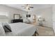 The main bedroom features natural light, dark dresser, and en suite bath at 11806 Stirling Field Dr, Pineville, NC 28134