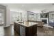 Open-concept kitchen flowing into the living room for seamless entertaining at 11806 Stirling Field Dr, Pineville, NC 28134