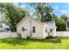 Spacious backyard with lush grass, a white fence, storage shed, and a small rear porch area at 1210 Jackson Rd, Gastonia, NC 28052