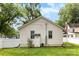 White home featuring a well-manicured lawn, privacy fence, and an exterior storage shed at 1210 Jackson Rd, Gastonia, NC 28052