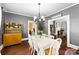 Charming dining room with hardwood floors, a chandelier, and a view into the living room, great for entertaining at 1210 Jackson Rd, Gastonia, NC 28052