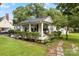 Inviting home with a spacious front yard, mature trees, and a charming porch, perfect for enjoying the outdoors at 1210 Jackson Rd, Gastonia, NC 28052