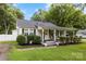 Attractive home boasts mature landscaping, a covered front porch perfect for relaxing, and classic architectural charm at 1210 Jackson Rd, Gastonia, NC 28052