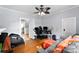 Living room with hardwood floors, fan and gray sofa at 1210 Jackson Rd, Gastonia, NC 28052