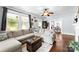 Spacious living room featuring a large sectional sofa, hardwood floors, and ample natural light, great for gatherings at 1210 Jackson Rd, Gastonia, NC 28052