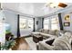 Comfortable living room with hardwood floors, large windows, and a spacious sectional sofa, perfect for relaxation at 1210 Jackson Rd, Gastonia, NC 28052