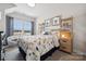 Bright bedroom with a dinosaur theme, large window, and cozy reading chair at 1225 Margo Mannor Dr, Fort Mill, SC 29708