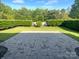 A stone patio in a large, beautiful backyard with green grass and a nice line of hedges at 13419 Morgan Lee Ave, Charlotte, NC 28213