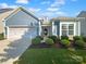Charming home featuring manicured landscaping, a two-car garage and blue siding at 13419 Morgan Lee Ave, Charlotte, NC 28213