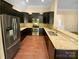 Spacious kitchen featuring dark cabinetry, granite countertops, and stainless steel appliances at 13419 Morgan Lee Ave, Charlotte, NC 28213