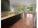 Open-concept kitchen featuring granite countertops, dark wood cabinets, and stainless steel appliances at 13419 Morgan Lee Ave, Charlotte, NC 28213