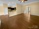 Open-concept living area with hardwood floors, modern lighting, and a view of the kitchen at 13419 Morgan Lee Ave, Charlotte, NC 28213