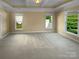 Bright and airy bedroom featuring neutral colors, carpet and large windows at 13419 Morgan Lee Ave, Charlotte, NC 28213