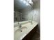 Bathroom featuring double sinks, modern fixtures, and a glass-enclosed shower for a bright and functional space at 156 Tarrington Dr, Statesville, NC 28625