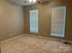 Neutral bedroom with carpet, ceiling fan and two windows that provide natural light at 156 Tarrington Dr, Statesville, NC 28625