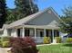 Charming home with a welcoming front porch, white columns, neutral siding, and well-manicured landscaping at 156 Tarrington Dr, Statesville, NC 28625