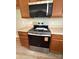 Kitchen showcasing stainless steel stove and microwave among wooden cabinets and countertops for a modern aesthetic at 156 Tarrington Dr, Statesville, NC 28625