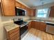 Modern kitchen with stainless steel appliances, granite countertops, and wood cabinets at 156 Tarrington Dr, Statesville, NC 28625