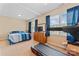 Bedroom with plush bed, dresser with TV, blue curtains, and a treadmill at 1609 Begonia Way, Rock Hill, SC 29732