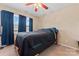 Comfortable bedroom with a cozy bed, ceiling fan, and blue curtains at 1609 Begonia Way, Rock Hill, SC 29732