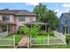 Charming two-story home featuring a white picket fence, a covered front porch, and nice landscaping at 1609 Begonia Way, Rock Hill, SC 29732