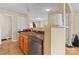 Functional kitchen featuring a stainless steel dishwasher, wood cabinets, and a tiled floor at 1609 Begonia Way, Rock Hill, SC 29732