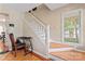 Well-lit staircase with hardwood steps and a white railing leading to the upper level at 1609 Begonia Way, Rock Hill, SC 29732
