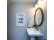 Stylish bathroom with decorative shelves and a gold-framed oval mirror at 1708 Roxborough Rd # C, Charlotte, NC 28211