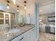 Elegant bathroom featuring granite counters and vanity with view to the main bedroom at 1708 Roxborough Rd # C, Charlotte, NC 28211