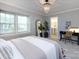 Bright bedroom featuring a chandelier, large windows, and an ensuite bathroom at 1708 Roxborough Rd # C, Charlotte, NC 28211