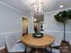 Bright dining room featuring a modern chandelier and stylish wood table at 1708 Roxborough Rd # C, Charlotte, NC 28211