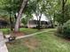 View of a multi-Gathering house with mature trees at 1708 Roxborough Rd # C, Charlotte, NC 28211