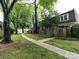 Exterior shot of a multi-Gathering home with mature trees and a sidewalk at 1708 Roxborough Rd # C, Charlotte, NC 28211