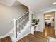 Bright foyer with staircase, white console table, wood-look floors, and access to the living area at 1708 Roxborough Rd # C, Charlotte, NC 28211