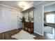 Hallway featuring wood floors, storage, and an open view into the living room at 1708 Roxborough Rd # C, Charlotte, NC 28211