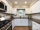 Bright kitchen featuring stainless steel appliances, granite countertops, white cabinets, and great lighting at 1708 Roxborough Rd # C, Charlotte, NC 28211