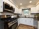 Well-appointed kitchen featuring stainless steel appliances, granite countertops, white cabinets, and great lighting at 1708 Roxborough Rd # C, Charlotte, NC 28211
