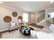Inviting living room with neutral tones, fireplace, staircase, and stylish decor at 1708 Roxborough Rd # C, Charlotte, NC 28211