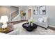 Bright living room featuring stylish furniture, decor, staircase, and wood-look floors at 1708 Roxborough Rd # C, Charlotte, NC 28211